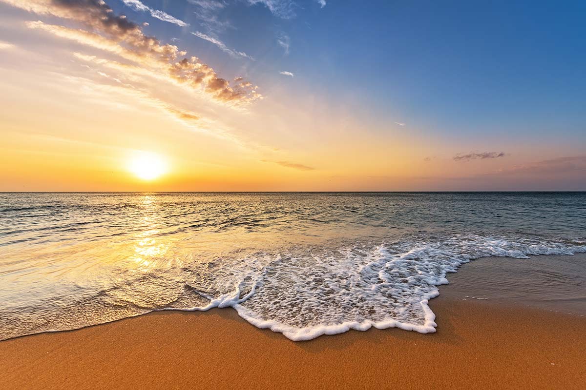 Standard-Motiv 1: Sonnenuntergang am Strand mit auslaufender Welle