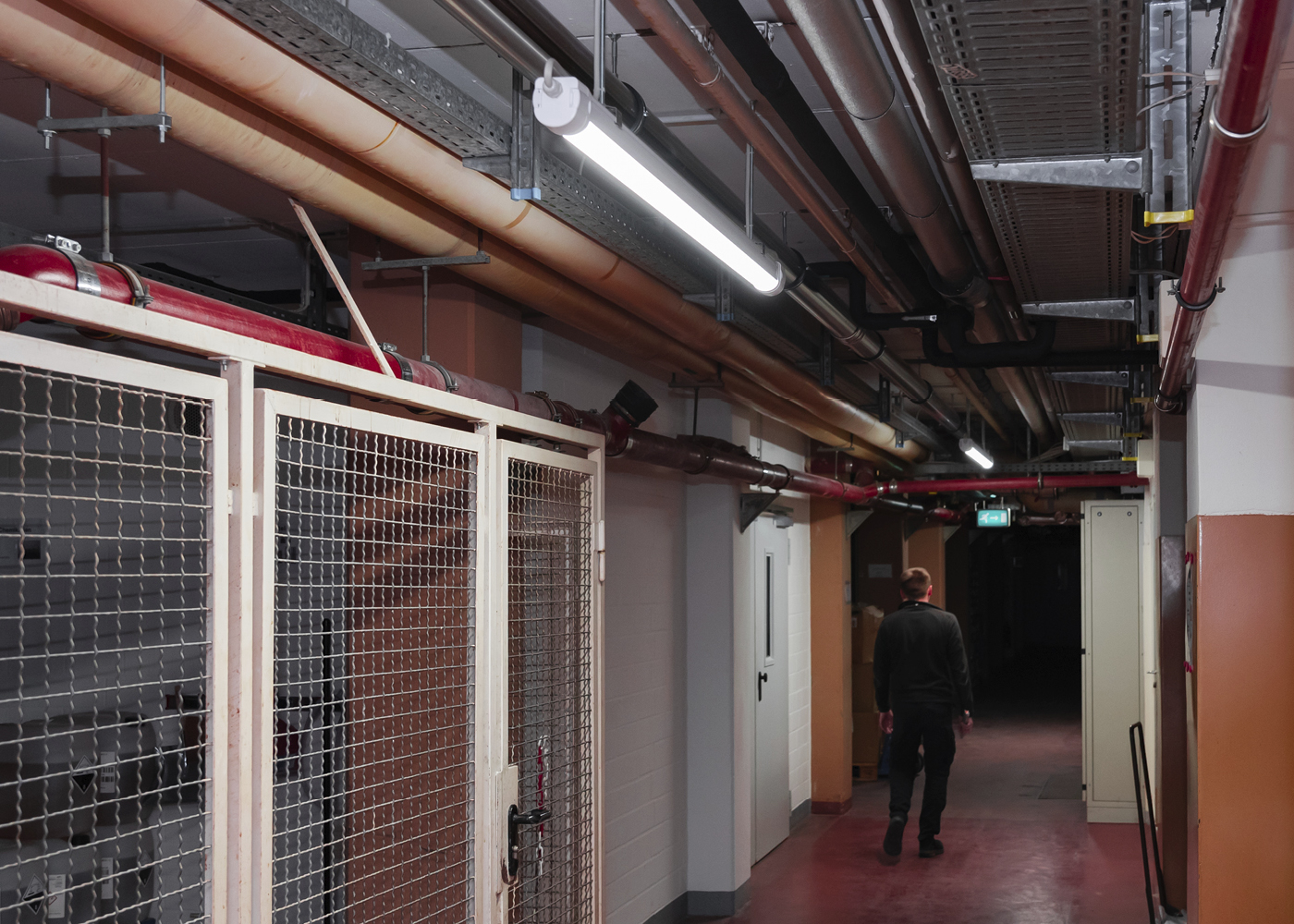 Anwendung Flur LED Langfeldleuchte IMPACTO smart mit Lichtschaltung bei Bewegungserkennung durch gehende Person